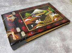 A Japanese lacquer musical table top photograph album, the cover hand painted with Mount Fuji and