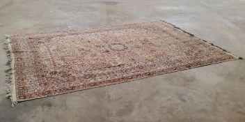 A substantial Persian Tabriz carpet in tones of cream, red and gold