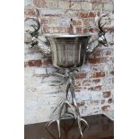An impressive chromed champagne bucket flanked my stag heads and mounted on a stag antlers 41cms