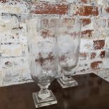 A pair of cut glass storm lanterns, heavy stepped square base, 34cm