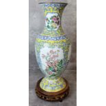 A Chinese hand painted enamel baluster shaped vase the body birds and flowering prunus set against a
