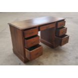 A late 19th/early 20th century knee-hole desk, central drawer to frieze flanked by three drawers