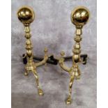 A pair of substantial brass andirons terminating in ball finials