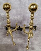 A pair of substantial brass andirons terminating in ball finials