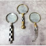 Three silver and gold plated decorative magnifying glasses