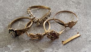A 9ct gold wishbone ring claw set with nine round white stones, 2.36g; a 9ct gold knot ring 1.78g; a