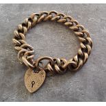 An early 20th century 9ct rose gold hollow charm bracelet, heart shaped padlock, engraved decoration