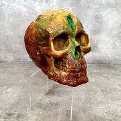 An unusual 'amber' carved skull, the skull decorated in relief with occult/Celtic symbolism 12cms