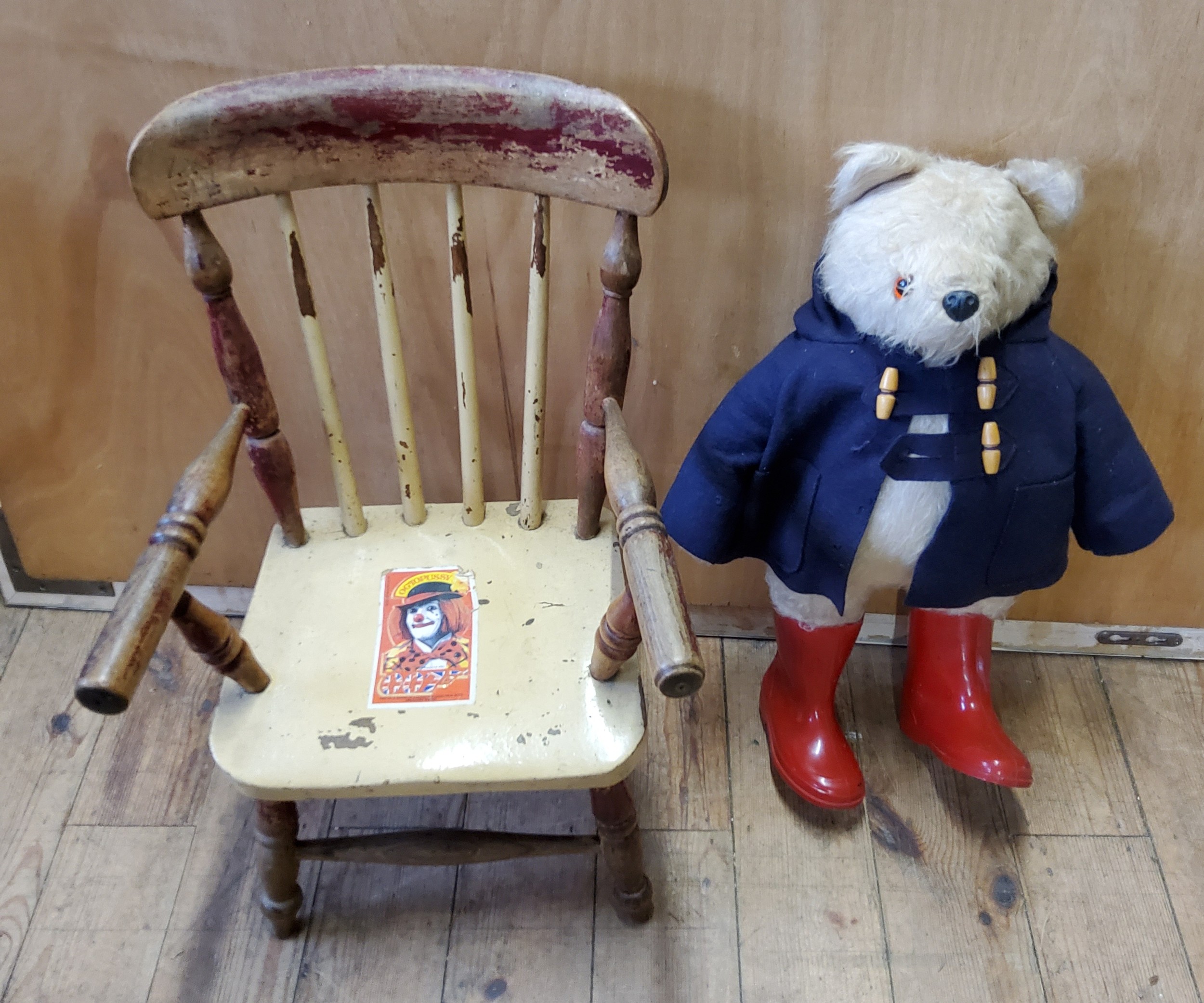 A 1980 Film Fare, Paddington Bear, blue duffle coat, red wellies,  Film Fare and chair