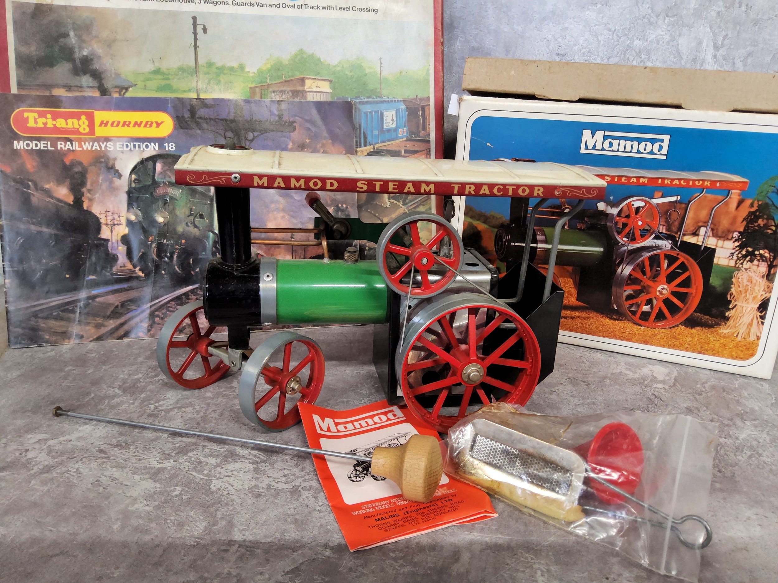A Mamod T.E.1A live steam traction engine, green with single smoke stack and canopy roof,