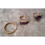 A 9ct gold wedding band 3.17g; a 9ct gold ring set with four oval purple amethysts 3.55g; a 9ct gold