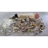 A quantity of silver & goldplated costume rings, including some set with white & coloured stones,
