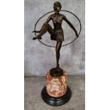 After Dominic Alonzo: a cast bronze figure of a semi-clad female hoop dancer the base with cast