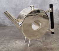 A silver plated teapot, after a design by Dr Christopher Dresser, of ring form, tube spout,