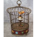 A brass novelty automaton table clock, as a bird in a cage, central posted globular dial with Arabic