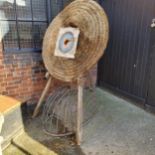 A large woven straw archery target