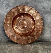An Arts & Crafts highly polished copper exhibition plate embossed and chased throughout, stamped H.
