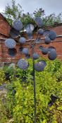 A substantial copper effect metal garden sculpture, the rotating branches decorated with stylish cup