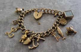 A 9ct gold charm bracelet, engraved heart shaped padlock, nine charms, one loose 29.44g