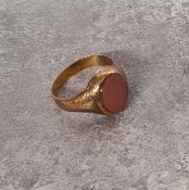 A 22ct gold signet ring set with an oval cornelian 4.27g gross;