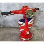 A good novelty table lamp in the form of a Vespa, red with the leg shield decorated with the Union