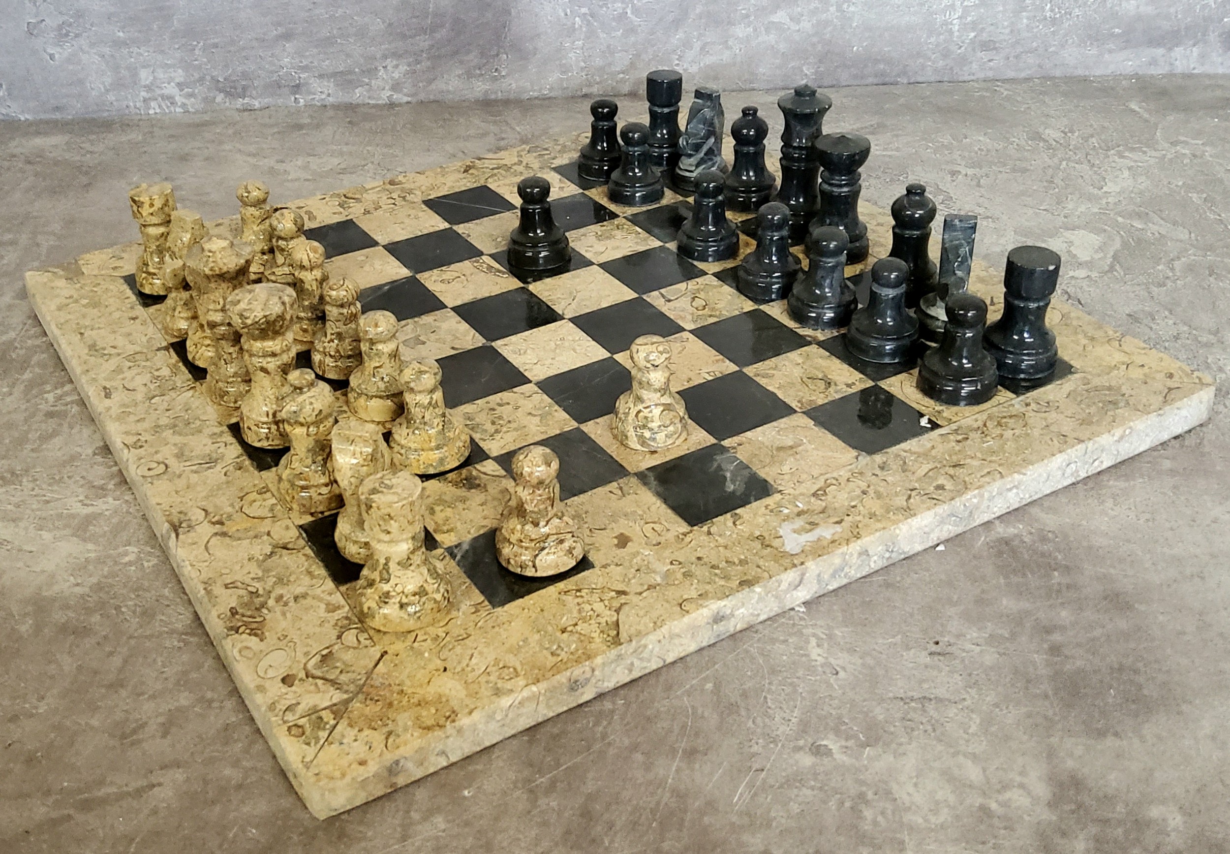 A highly polished fossilised coral and black marble chess set