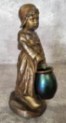 An unusual Dutch bronzed spelter and iridescent glass sculpture of a girl, indistinctly signed