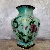 A large Vallauris Sevres pottery vase decorated with wild flower and butterflies on a pearlescent