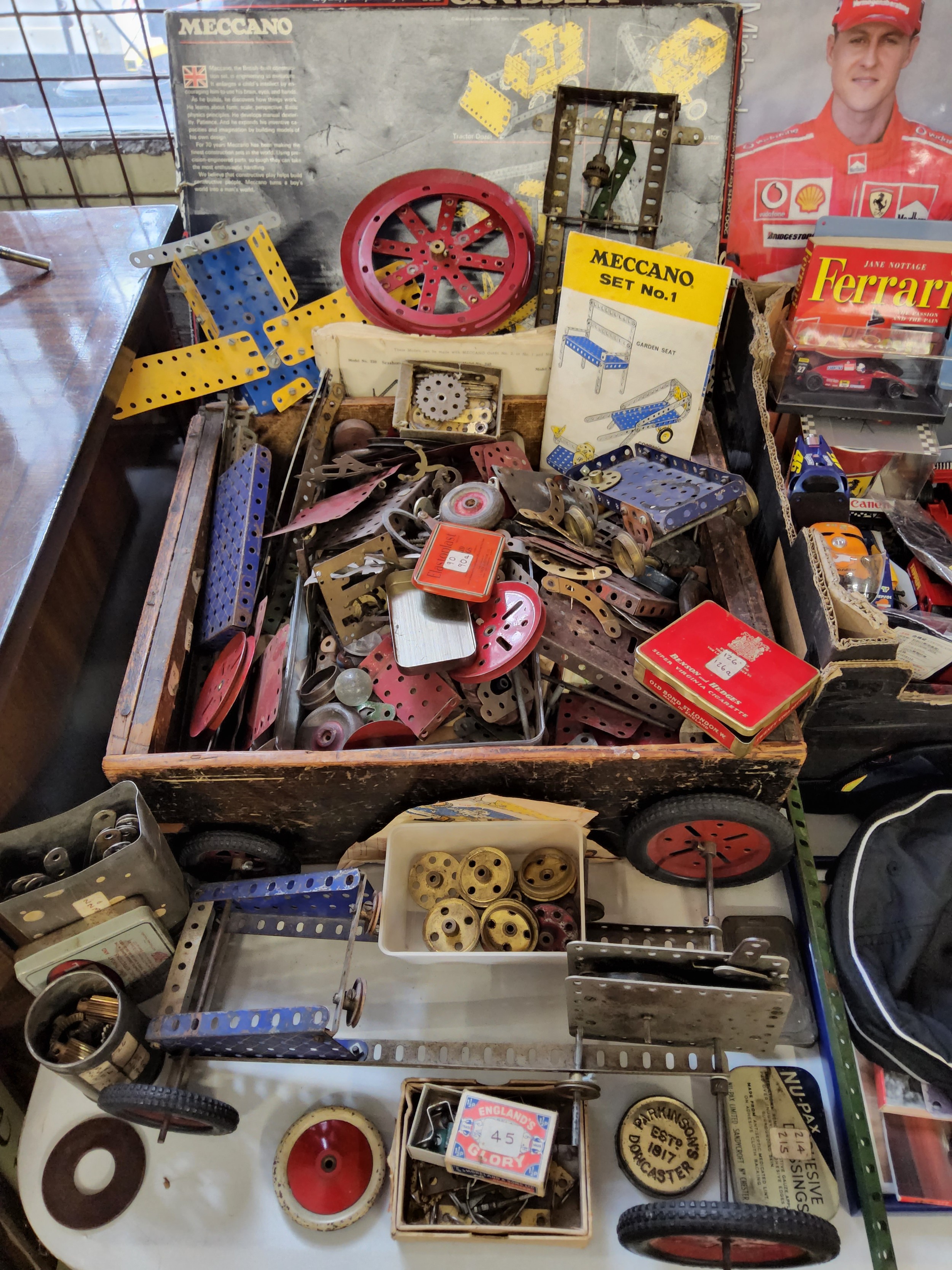 A quantity of vintage Meccano including wheels, clockwork motor, wheels & tyres, cogs etc. qty