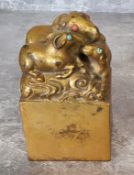 A gilt bronze Chinese seal in square form, three rat finial, base cut with four characters 10cms