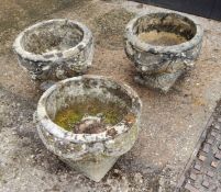 A set of three squat cast concrete planter / urn,  depicting bows and fruits 34cm h x 37.5 cm dia
