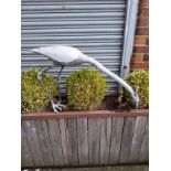 A large lead water feature statue of a feeding heron, 60 cm heigh x 100 cm long x 20 cm wide.