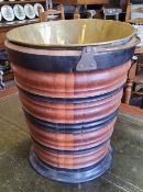 A Dutch walnut and ebonised kettle bucket, decorated with turned banded construction, with a brass