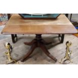 A Victorian mahogany Pembroke table, bold turned column with outswept fluted legs, brass castors