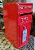 A reproduction 'ER' cast iron post box, in red livery with gilt detail, with two brass keys, 56cm