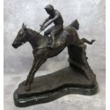 A bronze horse and jockey clearing a fence, veined belge noir marble base, 33cm high