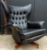 A G-Plan Model 6259 'Blofeld' armchair designed by Paul Conti, black leather swivel chair in