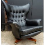 A G-Plan Model 6259 'Blofeld' armchair designed by Paul Conti, black leather swivel chair in