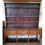 A George III kitchen dresser with three long cock beaded drawers to frieze, the period brass