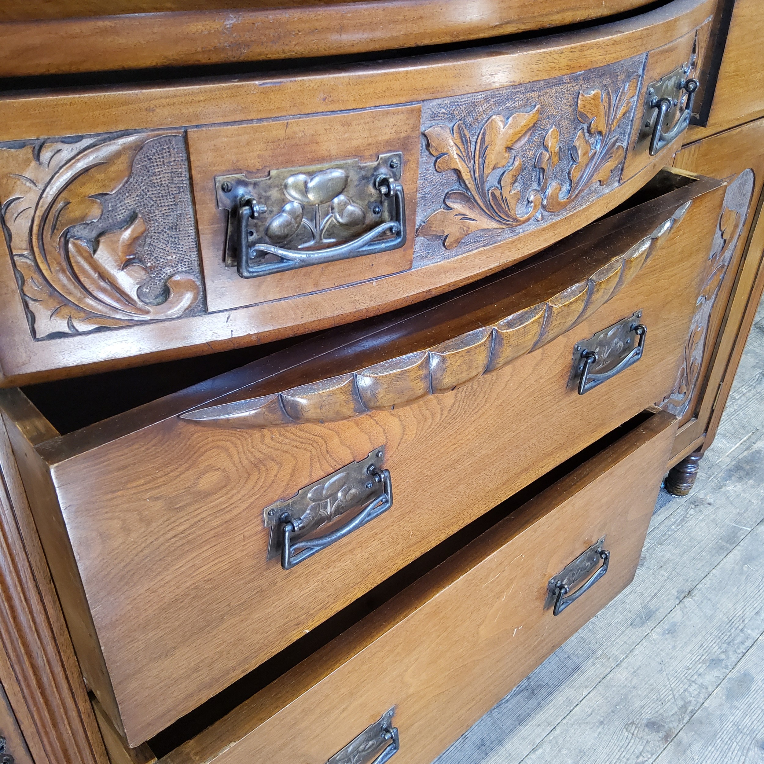An early 20th century oak bow fronted breakfront sideboard with oversized Art Nouveau escutcheons - Image 3 of 4