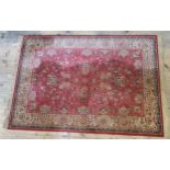 Kirman Shah Wool Tassled Rug, allover floral motifs in the paisley manner, on a deep red ground