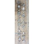 A pair of decorative silvered hanging wall sconces 133cms H