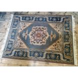 A contemporary Turkish Oushak type rug in tones of blue and gold 227cm x 170cm