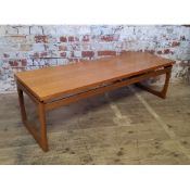 A large mid 20th century teak G Plan coffee table, red label, 137 wide x 46 deep x 42.5cm high