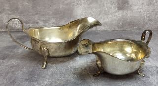 A silver sauce boat, scallop edged, pad feet, Viners, Sheffield, 1933 148.2g; another smaller 107.3g