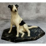 An early 20th century painted plaster library model of a Jack Russell on a faux marble base c.