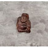 A Chinese padouk wood ink well in the form of a cheerful Bhudda, small signed mother of pearl
