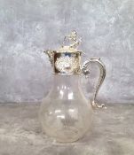 An elegant silver plate mounted claret jug, terminating with a lion and shield hinged lid with green