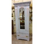 A 19th century French single wardrobe with applied Neo Classical swags, single drawer to frieze,