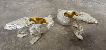 A silver plated novelty salts in the form of anthropomorphic frogs pulling a snail shell, the
